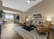 Thumbnail 3 of 19 - A living room with a brown leather chair and a grey and white rug.
