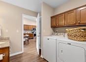 Thumbnail 19 of 20 - A laundry room with a washer and dryer.