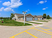 Thumbnail 2 of 19 - A street view of a residential area with houses and a street sign.