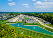 Thumbnail 8 of 19 - A large community with a pond and fountain in the middle.