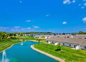Thumbnail 9 of 19 - A beautiful residential area with a lake and a fountain.