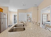 Thumbnail 5 of 19 - A kitchen with granite countertops and stainless steel appliances.