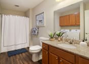 Thumbnail 16 of 19 - A bathroom with a toilet, sink, and shower.