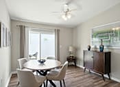 Thumbnail 11 of 19 - A dining room with a table, chairs, and a ceiling fan.