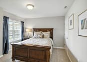 Thumbnail 15 of 19 - A bedroom with a large bed and a painting on the wall.