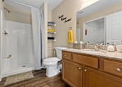 Thumbnail 19 of 19 - A bathroom with a white toilet and a white sink.