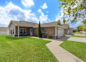 Thumbnail 2 of 19 - A row of houses with a sidewalk in front.