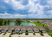 Thumbnail 10 of 19 - A suburban neighborhood with houses and a lake.