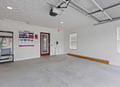 Thumbnail 9 of 19 - A room with a white wall and a red door.