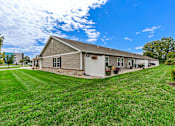 Thumbnail 3 of 19 - A house with a grey roof and a white garage door.