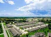 Thumbnail 17 of 19 - A bird's eye view of a residential area with houses and green lawns.