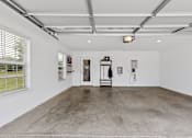 Thumbnail 19 of 19 - A large, empty room with a concrete floor and white walls.