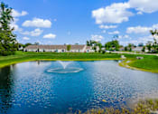 Thumbnail 8 of 19 - A fountain in the middle of a lake in a park.
