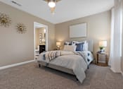 Thumbnail 16 of 19 - A bedroom with a large bed and a ceiling fan.