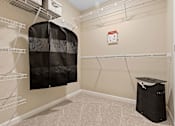 Thumbnail 13 of 19 - A room with a closet and a trash bin.