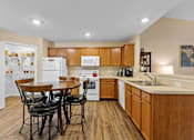 Thumbnail 6 of 20 - A kitchen with wooden cabinets and a white fridge.