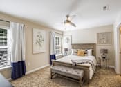 Thumbnail 10 of 11 - a bedroom with a large bed and a ceiling fan