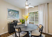 Thumbnail 4 of 11 - a dining room with a table and chairs and a window