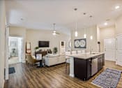 Thumbnail 5 of 11 - a living room with a kitchen and a dining room