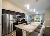 Thumbnail 3 of 11 - a kitchen with stainless steel appliances and a granite counter top