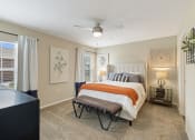 Thumbnail 8 of 10 - a bedroom with a bed and a ceiling fan