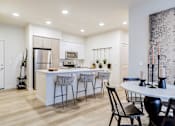 Thumbnail 15 of 33 - an open kitchen and dining area with a table and chairs