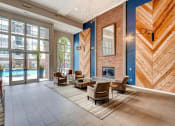 Thumbnail 3 of 25 - a lobby with a fireplace and chairs and a rug