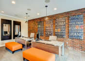 Thumbnail 11 of 25 - a brick wall in an office with two desks and orange chairs