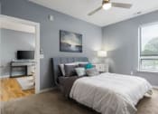 Thumbnail 6 of 12 - a bedroom with a bed and a ceiling fan