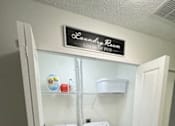 Thumbnail 13 of 21 - A laundry room with a sign that says "Laundry Room" on the wall.