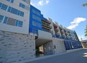 Thumbnail 9 of 12 - a large blue building with a street in front of it