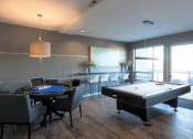 Thumbnail 8 of 12 - a living room with a pool table and a bar