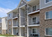 Thumbnail 4 of 13 - Apartment building with balconies and windows.