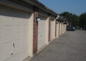Thumbnail 5 of 8 - A row of white garage doors are closed.