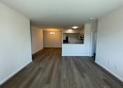Thumbnail 4 of 6 - A room with a kitchen area in the background at Hamlet On The Bend, Hebrun