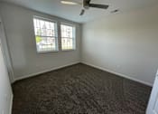Thumbnail 6 of 6 - A room with a ceiling fan and carpeted floor at Hamlet On The Bend, Hebrun, KY, 41048