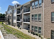 Thumbnail 3 of 6 - A multi-story apartment building with balconies and windows at Hamlet On The Bend, Hebrun, KY, 41048