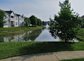 Thumbnail 13 of 17 - A tree stands on the grass next to a river. at Twin Fountains Apartments, Ohio, 45040