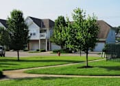 Thumbnail 12 of 17 - A tree in front of a house with a red fire hydrant in the front yard. at Twin Fountains Apartments, Ohio