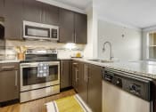 Thumbnail 54 of 63 - a kitchen with stainless steel appliances and granite counter tops at Vanguard Crossing, Missouri