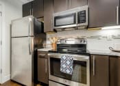 Thumbnail 53 of 63 - a kitchen with stainless steel appliances and a stainless steel refrigerator at Vanguard Crossing, Missouri 63124