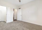 Thumbnail 45 of 63 - a bedroom with white walls and carpet and white doors at Vanguard Crossing, St. Louis