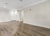 Thumbnail 51 of 63 - an empty living room with white walls and wood floors at Vanguard Crossing, Missouri 63124