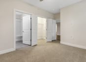 Thumbnail 55 of 63 - an empty bedroom with two closets and a bathroom at Vanguard Crossing, Missouri
