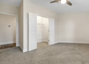 Thumbnail 56 of 63 - an empty living room with a closet and a ceiling fan at Vanguard Crossing, St. Louis