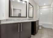 Thumbnail 48 of 63 - a bathroom with a sink and a toilet and a shower at Vanguard Crossing, St. Louis, MO 63124