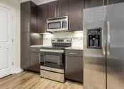 Thumbnail 40 of 63 - a kitchen with stainless steel appliances and a stainless steel refrigerator at Vanguard Crossing, St. Louis, MO