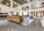 Thumbnail 1 of 63 - a lobby with couches and chairs and a table with lamps at Vanguard Crossing, St. Louis, 63124