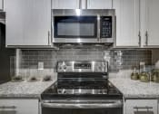 Thumbnail 6 of 51 - Electric Range In Kitchen at Riachi at One21, Plano, Texas