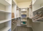 Thumbnail 10 of 52 - a walk in closet with shelves and shoes at Aster Apartments, Ohio, 44122